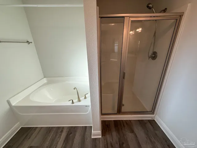 a bathroom with a tub and shower