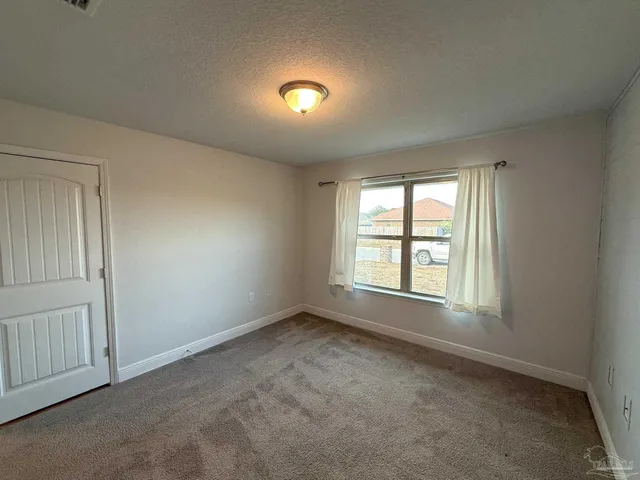 an empty room with a empty space and windows