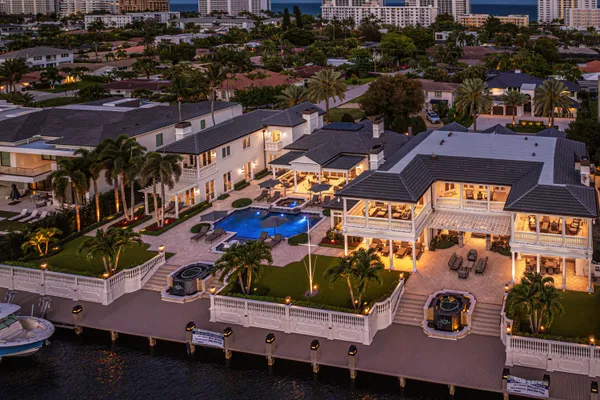 a aerial view of a house with a swimming pool and outdoor seating