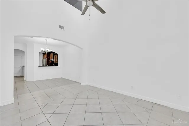 an empty room with cabinet and mirror