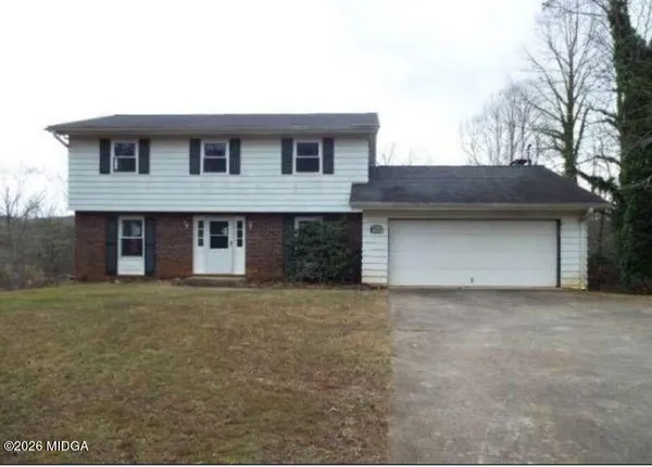 a front view of a house with a yard and garage