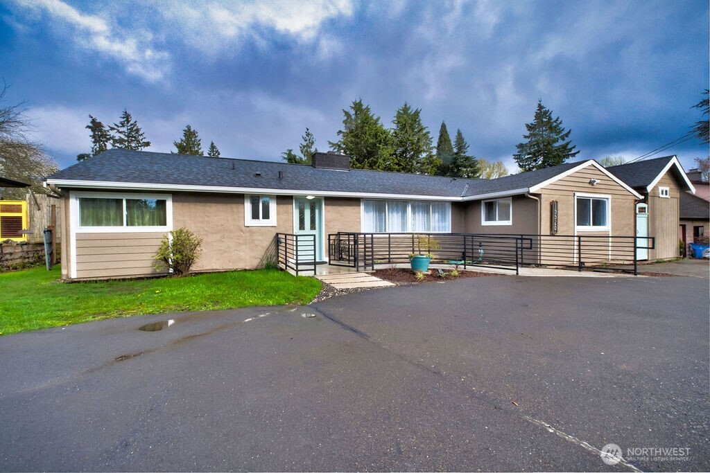 15520 30th Avenue Northeast Shoreline, WA 98155 - Photo 16 of 17 a front view of a house with a yard and garage