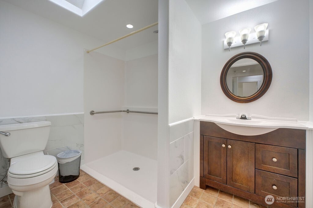 15520 30th Avenue Northeast Shoreline, WA 98155 - Photo 8 of 17 a bathroom with a sink a toilet and a mirror