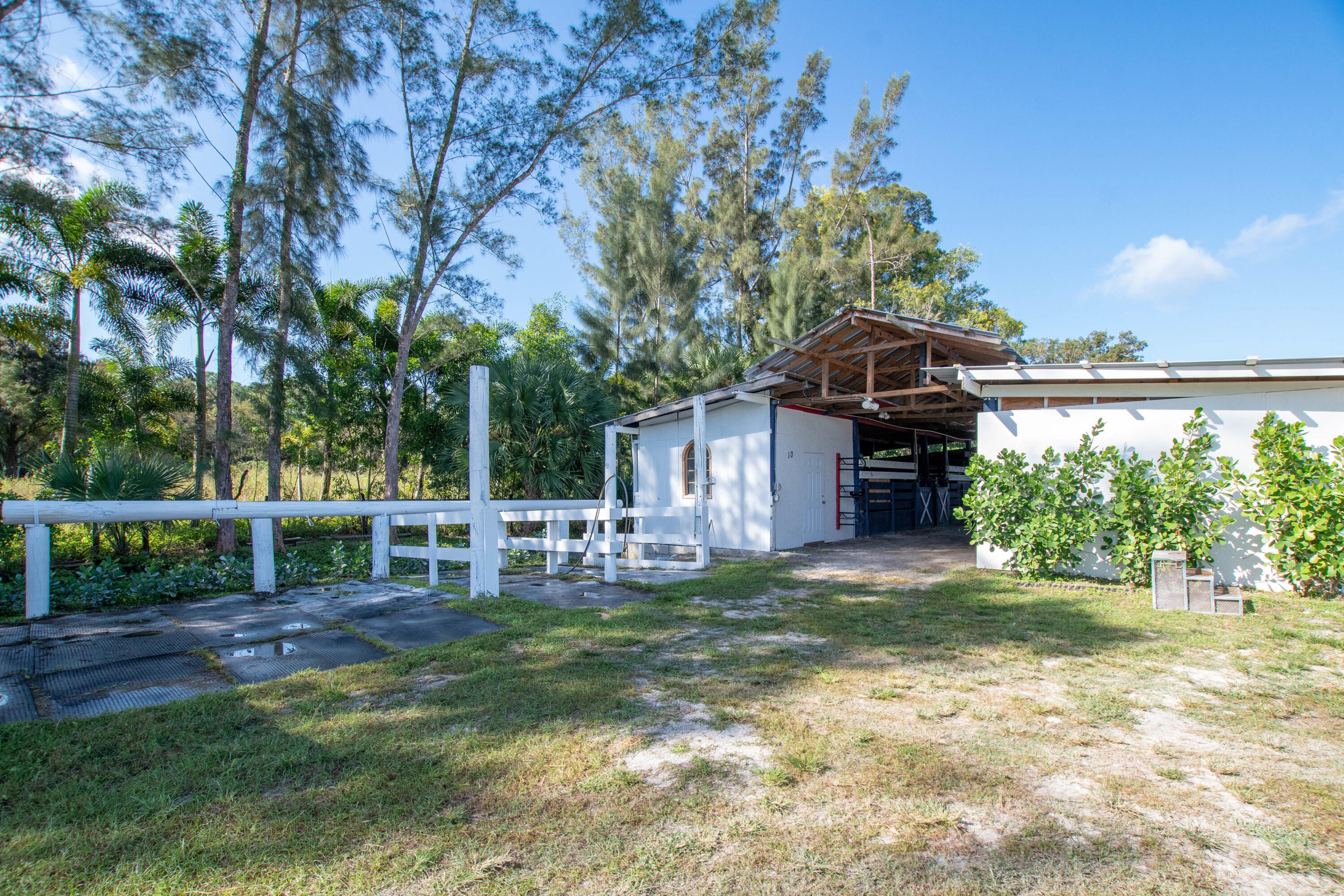 1044 D Road Loxahatchee Groves, FL 33470 - Photo 15 of 36 a view of a house with a yard porch and sitting area