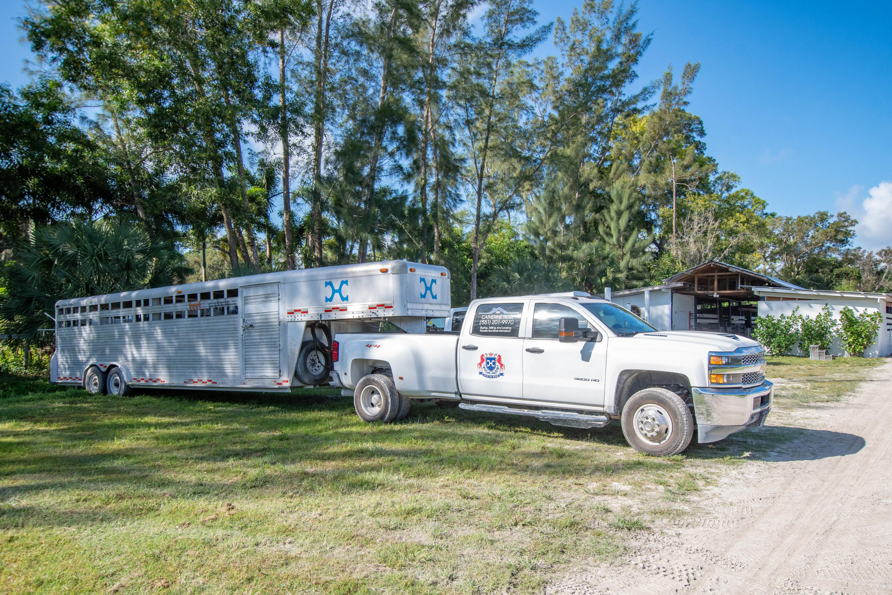 1044 D Road Loxahatchee Groves, FL 33470 - Photo 21 of 36 a car parked in front of a house with a yard