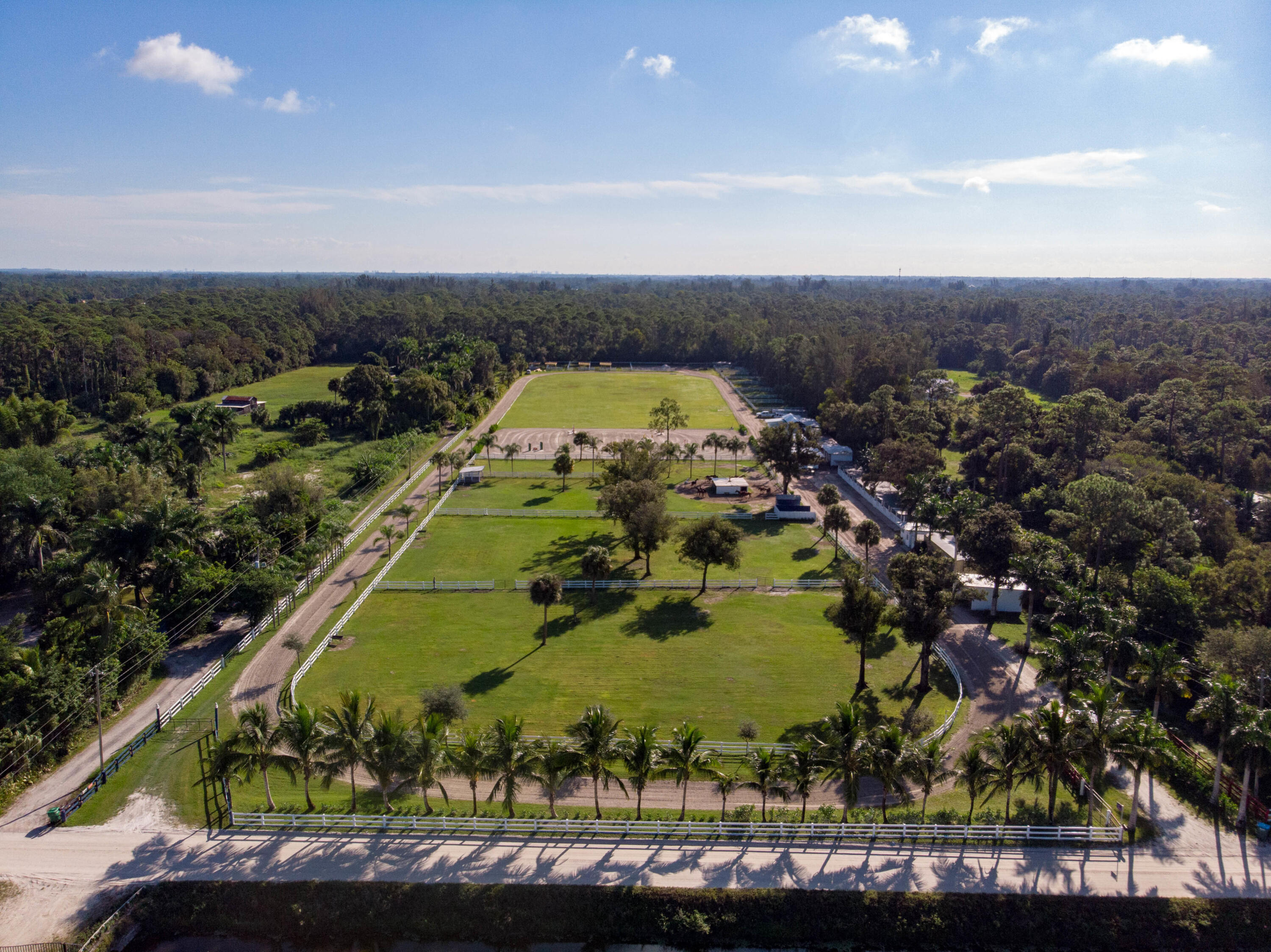 1044 D Road Loxahatchee Groves, FL 33470 - Photo 27 of 36 an aerial view of a residential houses with outdoor space and swimming pool