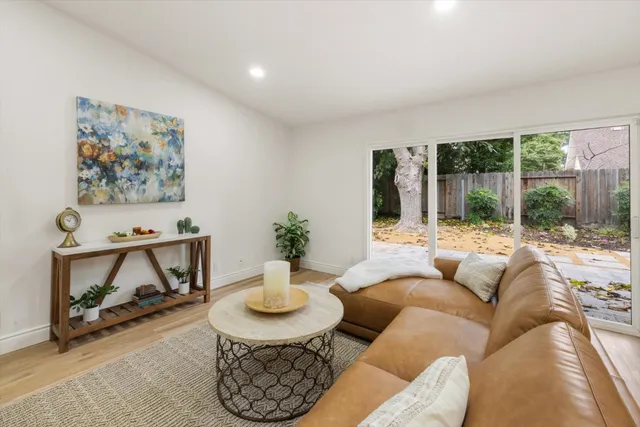 a kitchen with stainless steel appliances kitchen island granite countertop a sink a refrigerator and chairs