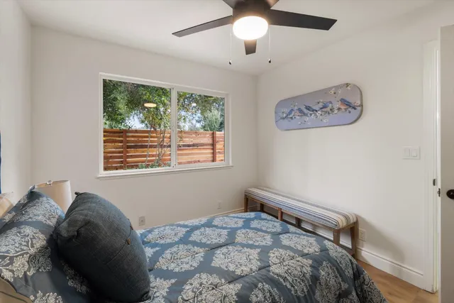 a spacious bedroom with a bed and a large window