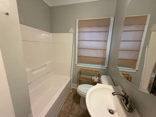 a bathroom with a sink a toilet and bathtub