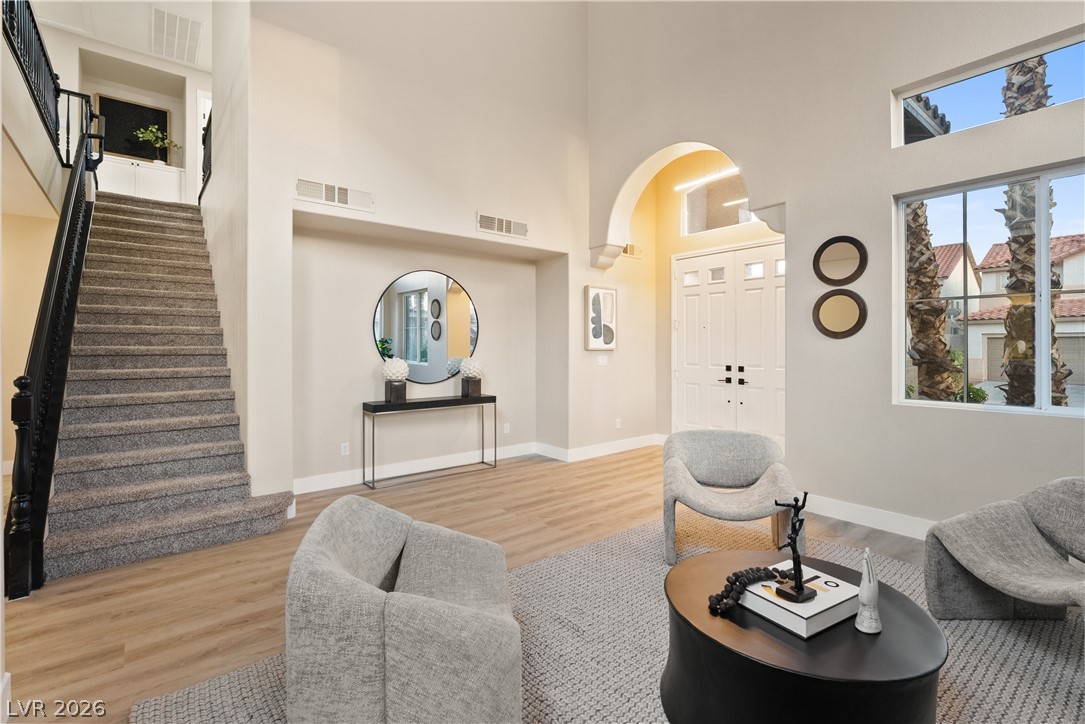 1662 Ravanusa Drive Henderson, NV 89052 - Photo 68 of 74 A grand entrance welcomes guests with soaring ceilings, a sweeping staircase, and sun-filled windows.