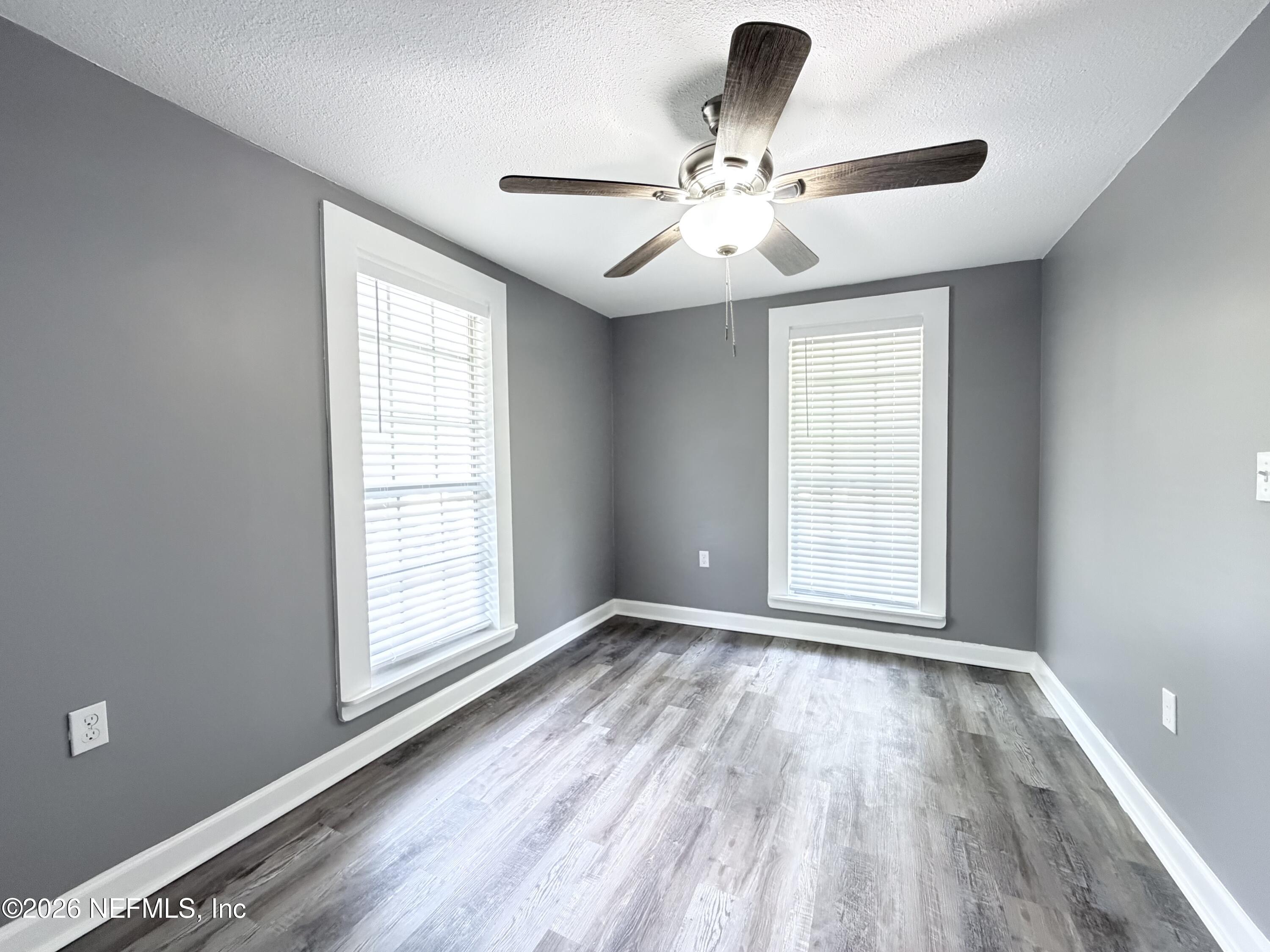 5336 Cruz Road Jacksonville, FL 32207 - Photo 15 of 29 wooden floor in an empty room with a window
