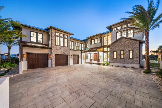 a front view of a house with yard and umbrellas