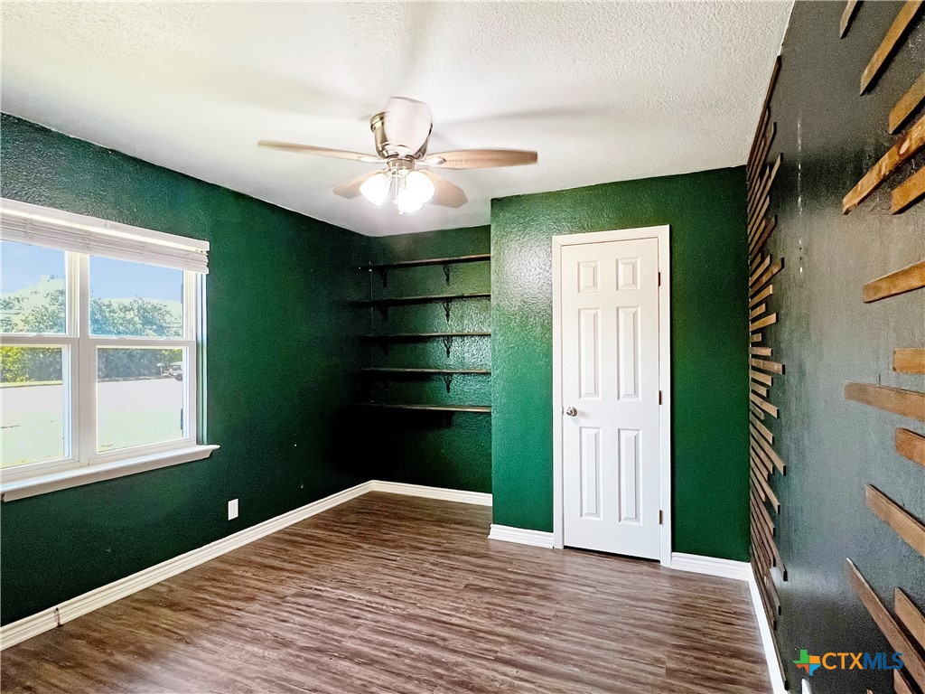1311 West Main Street Gatesville, TX 76528 - Photo 15 of 30 a bedroom with a bed and a window