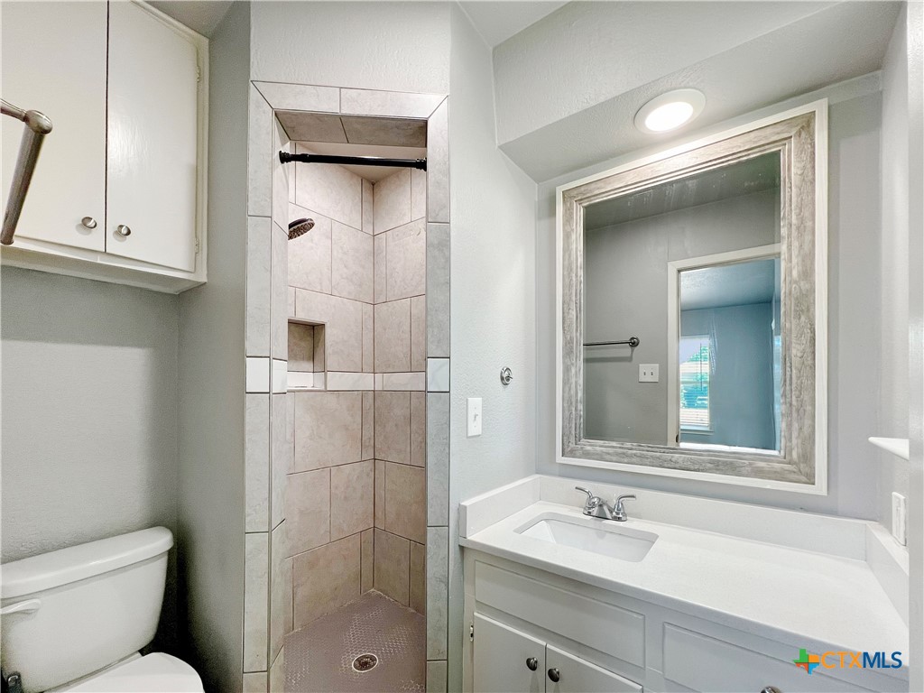 1311 West Main Street Gatesville, TX 76528 - Photo 18 of 30 a bathroom with a sink toilet and shower
