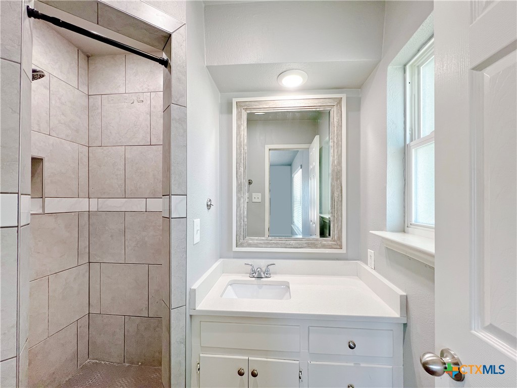 1311 West Main Street Gatesville, TX 76528 - Photo 19 of 30 a bathroom with a sink and a mirror