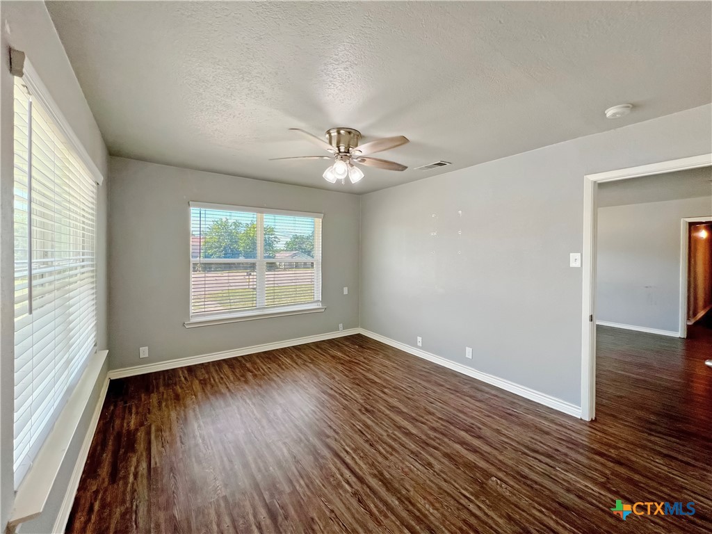 1311 West Main Street Gatesville, TX 76528 - Photo 20 of 30 wooden floor in an empty room with a window