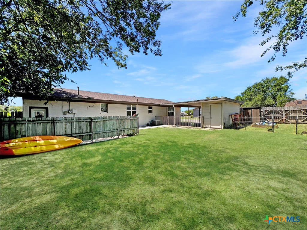 1311 West Main Street Gatesville, TX 76528 - Photo 28 of 30 a view of a swimming pool with lawn chairs under an umbrella