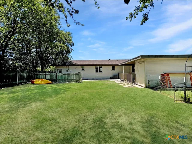 a view of a house with a backyard