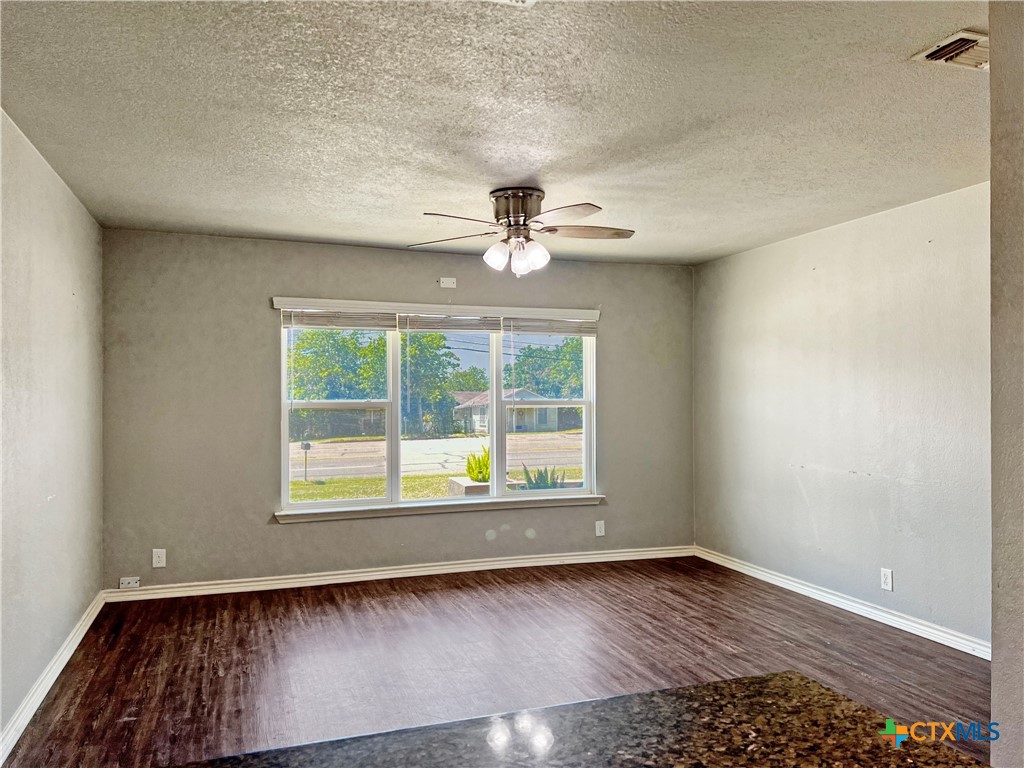 1311 West Main Street Gatesville, TX 76528 - Photo 10 of 30 wooden floor in an empty room with a window