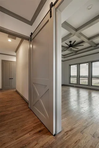 a view of water heater room with wooden floor