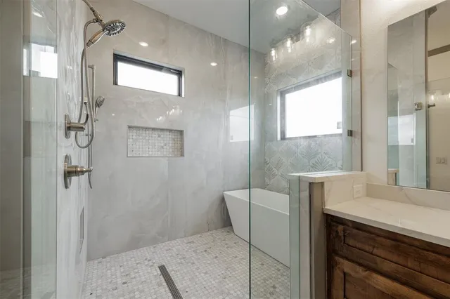 a bathroom with a sink a toilet a glass door and shower