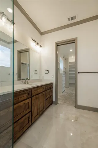 a spacious bathroom with a granite countertop sink mirror and a shower