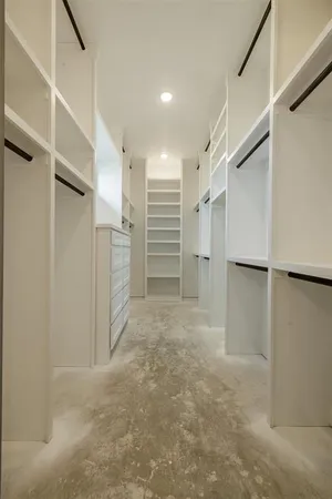 a view of walk in closet with empty racks