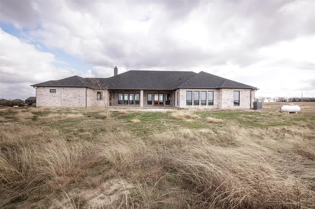 a large house with a big yard and large trees