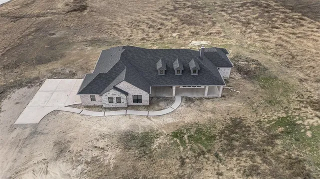an aerial view of a house with yard patio and backyard