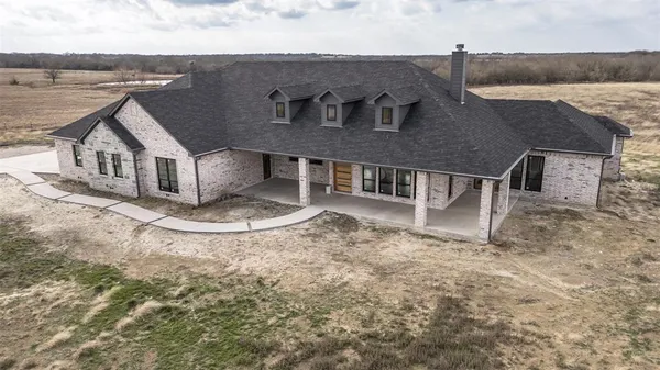 an aerial view of a house with a yard and balcony