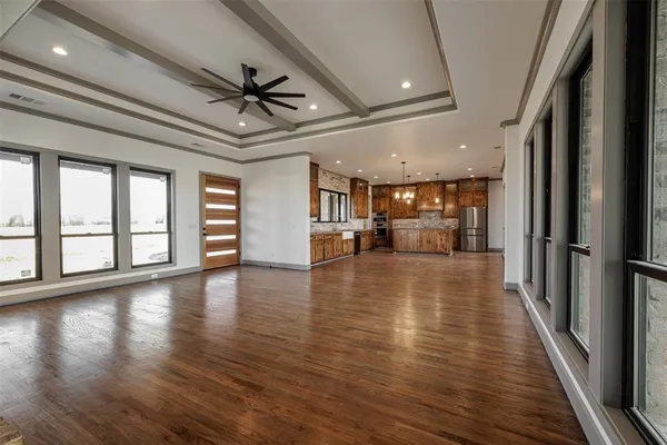 a view of empty room with wooden floor