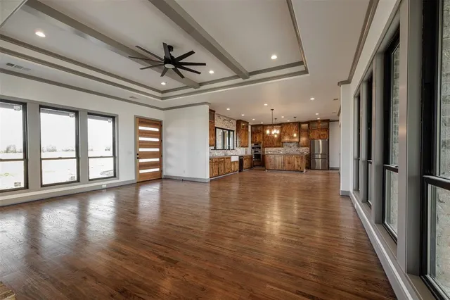 a view of empty room with wooden floor