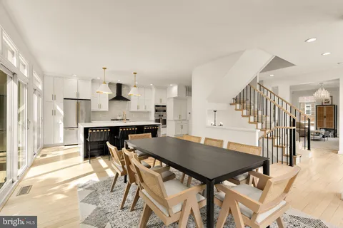 a dining room with kitchen island a table and chairs