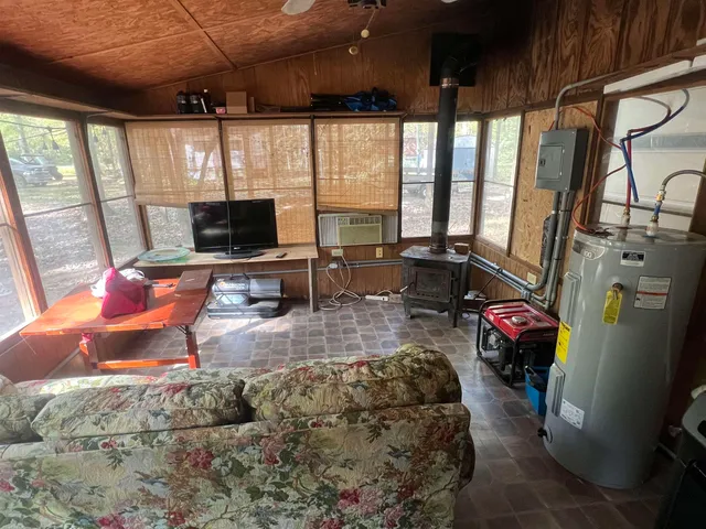 a living room with furniture a flat screen tv and a large window