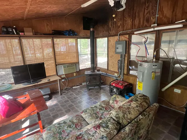 a bedroom with furniture and a flat screen tv