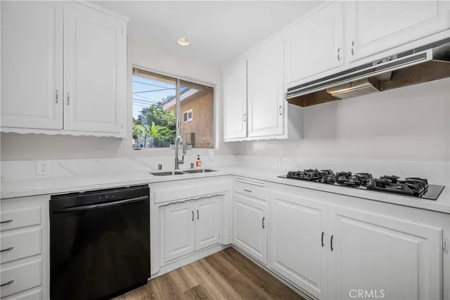 a kitchen with stainless steel appliances a refrigerator and a stove top oven