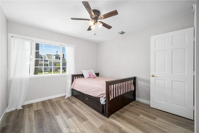 a room with a bed and wooden floor