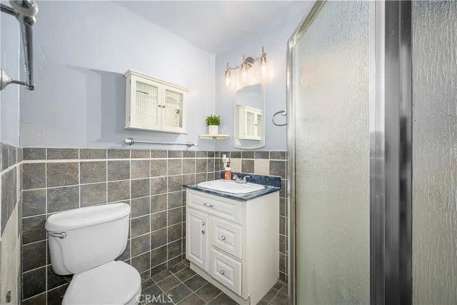 a bedroom with a bed and a chandelier fan