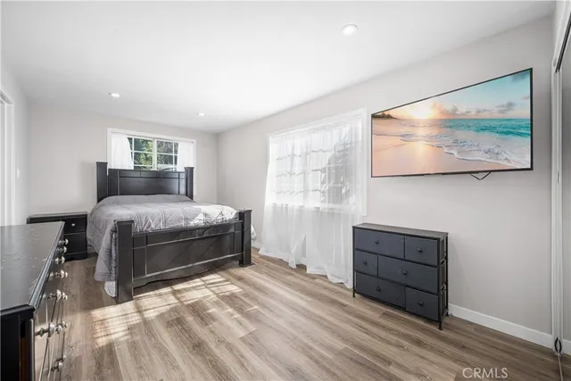 a bathroom with a granite countertop toilet a sink and a mirror