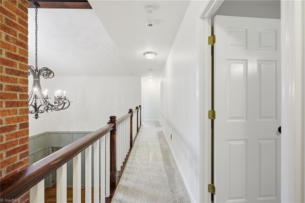 8861 Boylston Road Colfax, NC 27235 - Photo 26 of 50 New carpet (2026) leads to the upper level overlooking the soaring two-story great room.