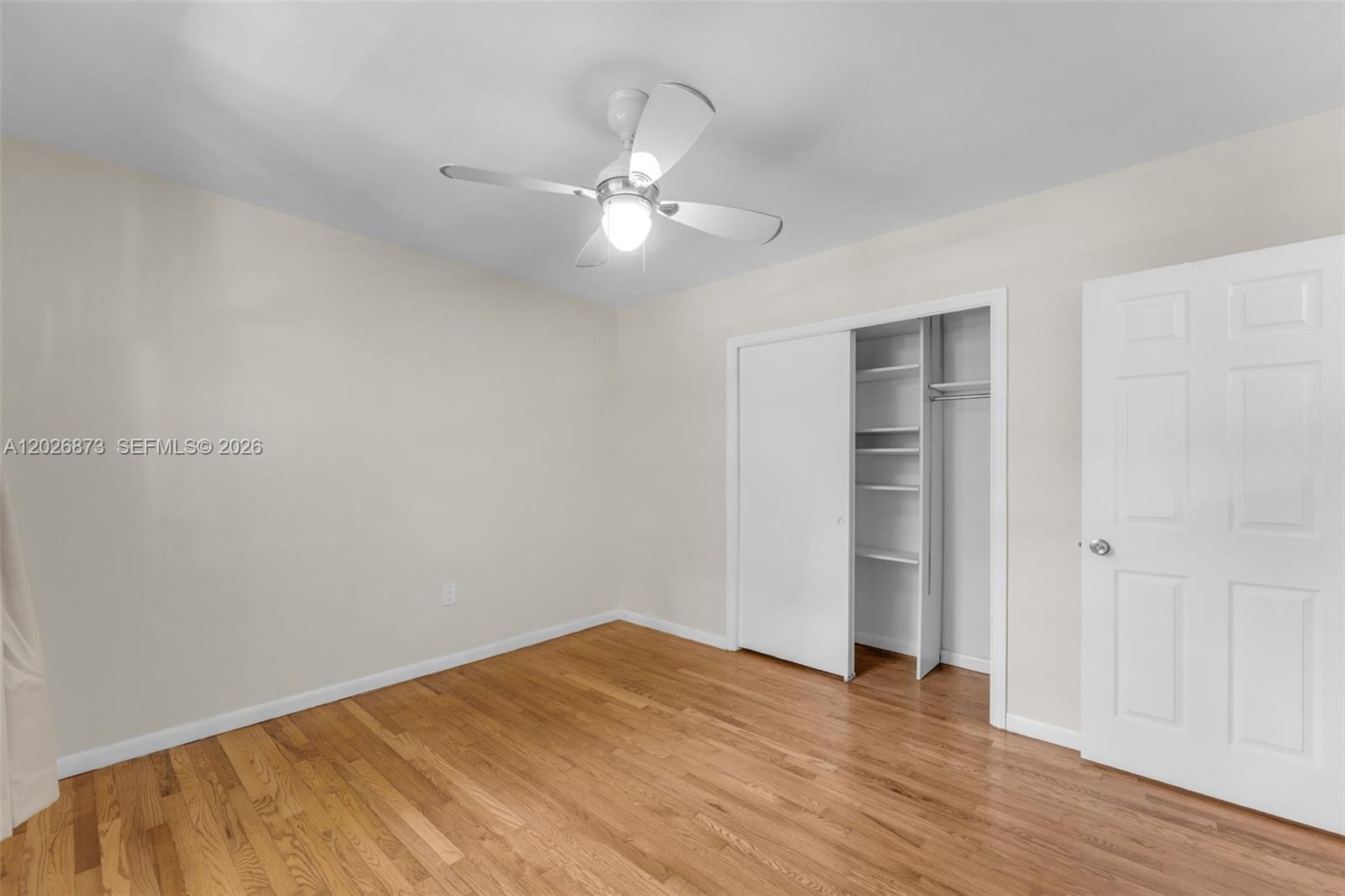 5590 Southwest 78th Street, Unit 133B Miami, FL 33143 - Photo 8 of 18 a view of empty room with wooden floor and fan