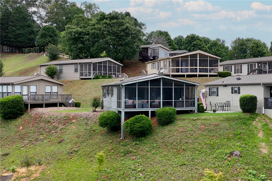 1230 Melton Road, Unit 4 West Union, SC 29696 - Photo 3 of 48 Perched on a verdant hillside, these charming homes feature delightful screened-in porches, perfect for enjoying the scenery.