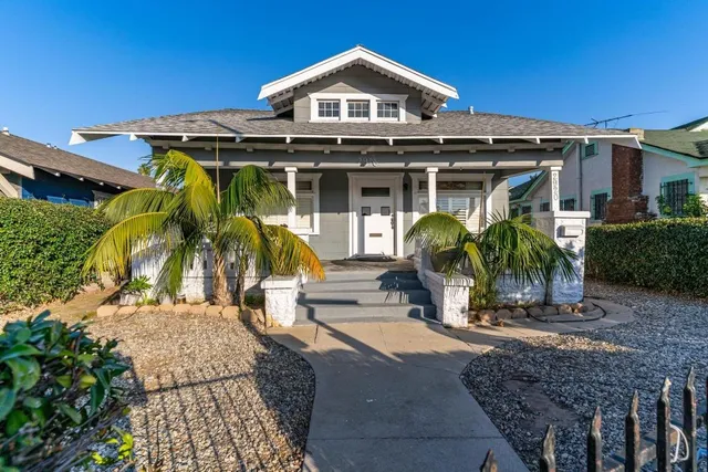 a view of a white house with large windows