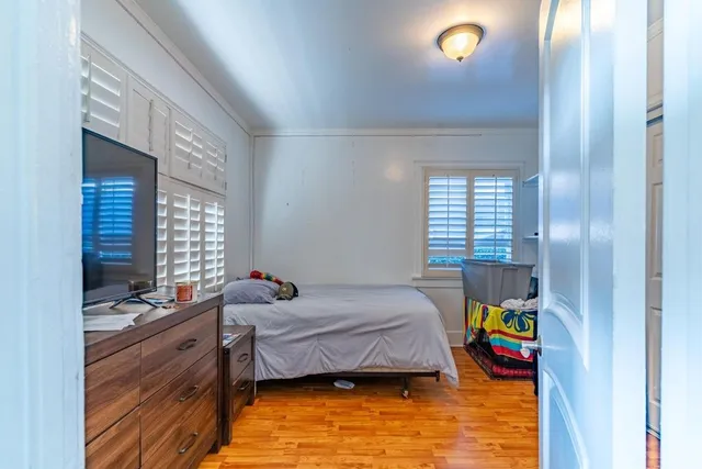 a bed room with a bed and a window