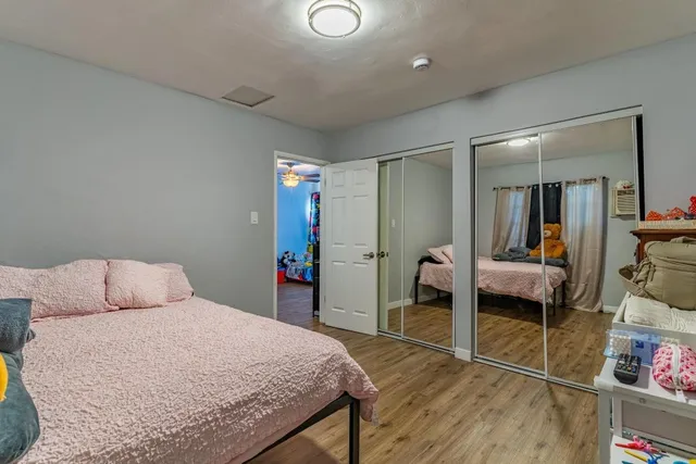 a bedroom with a bed and a mirror