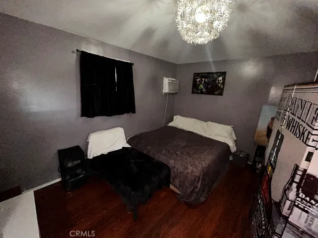 a bedroom with a bed and a night stand