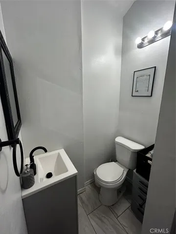 a white toilet sitting next to a bathroom sink
