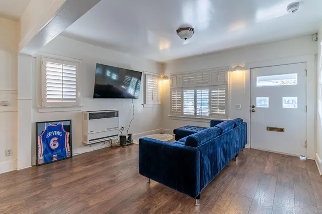 a living room with fireplace furniture and a flat screen tv