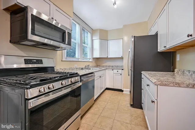 a kitchen with cabinets and appliances