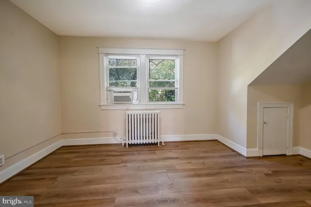 a view of a livingroom with wooden floor and a ceiling fan